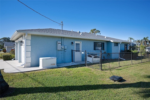 rear view of property with a yard