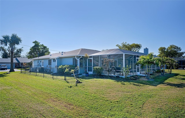 view of front facade with a lanai and a front lawn