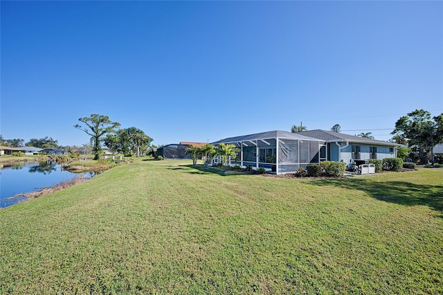 view of yard featuring a lanai and a water view