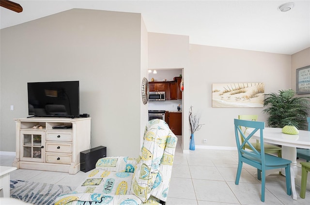 living room featuring vaulted ceiling and light tile patterned floors