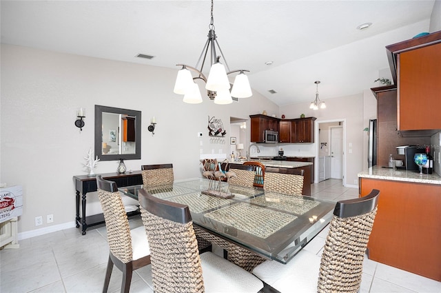 tiled dining area featuring vaulted ceiling and an inviting chandelier