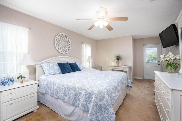 bedroom with ceiling fan and light colored carpet