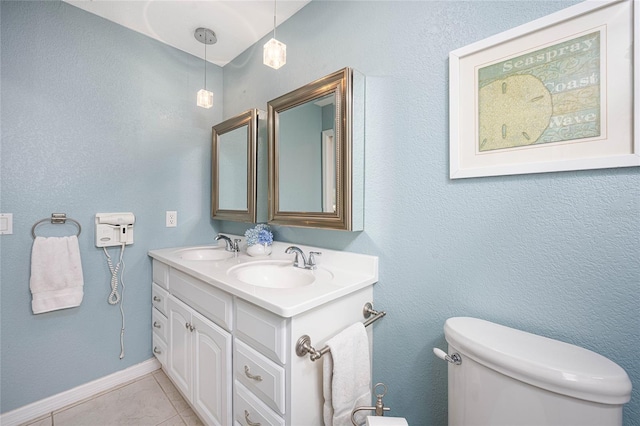 bathroom featuring toilet, tile patterned floors, and vanity