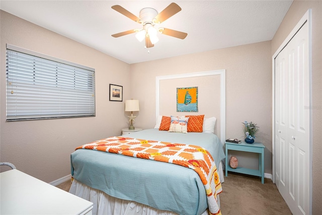 carpeted bedroom featuring a closet and ceiling fan