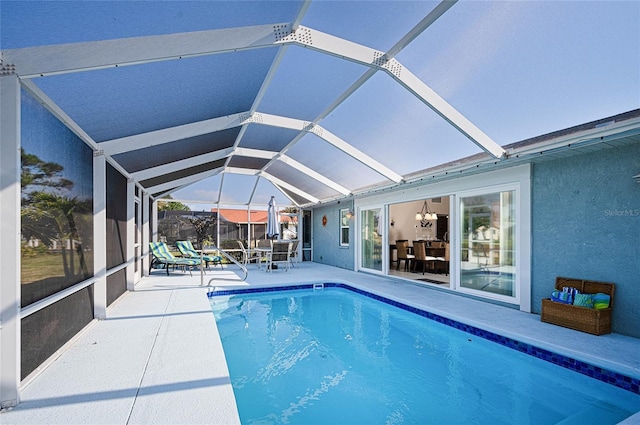 view of swimming pool with a lanai and a patio area