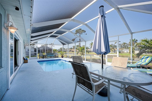 view of swimming pool featuring glass enclosure and a patio