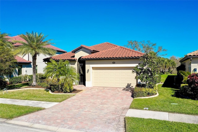 mediterranean / spanish house with a front yard and a garage