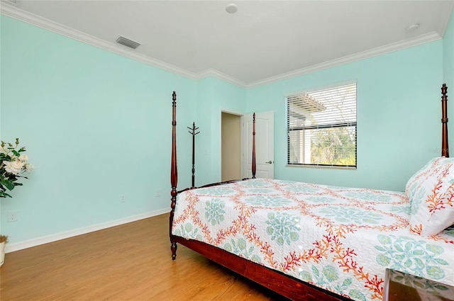 bedroom featuring wood-type flooring and ornamental molding