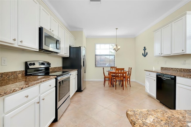 kitchen featuring appliances with stainless steel finishes, dark stone counters, ornamental molding, a notable chandelier, and white cabinets