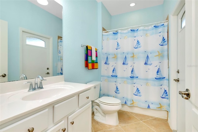 bathroom featuring tile patterned flooring, vanity, toilet, and walk in shower