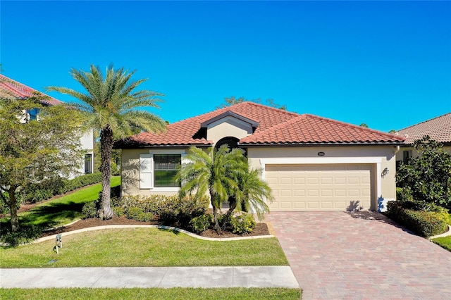 mediterranean / spanish house with a front yard and a garage