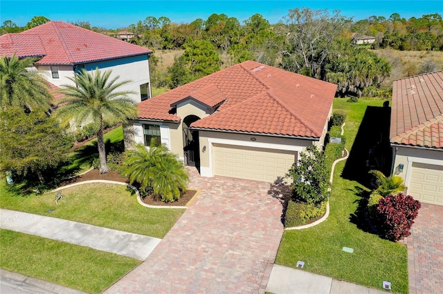 view of front of home with a front lawn and a garage