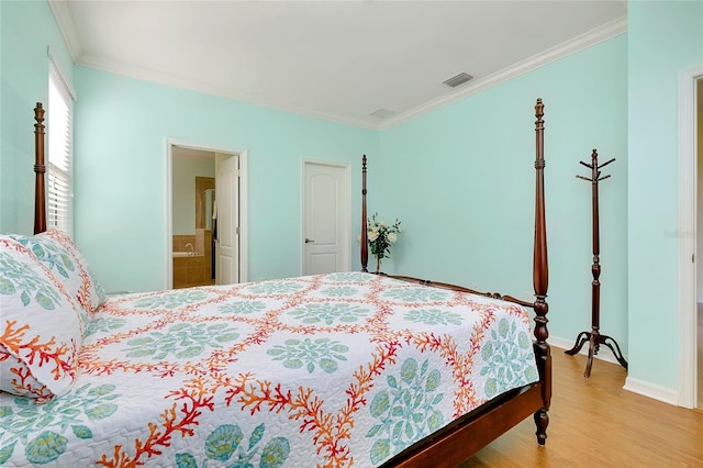 bedroom with connected bathroom, crown molding, and light wood-type flooring