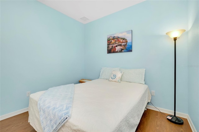 bedroom with hardwood / wood-style floors