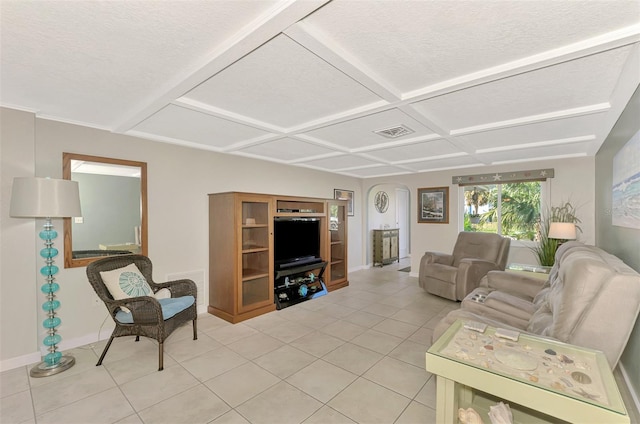 living room featuring a textured ceiling, coffered ceiling, and light tile patterned flooring