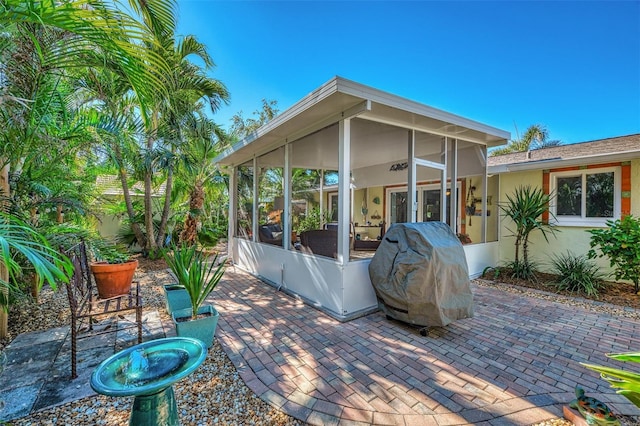 view of patio featuring area for grilling and a sunroom