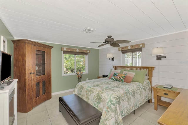 tiled bedroom with ceiling fan, crown molding, wooden walls, and multiple windows