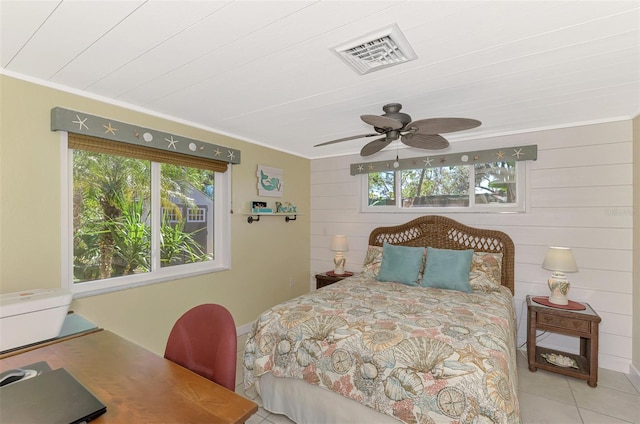 tiled bedroom with ceiling fan, wood walls, wooden ceiling, and crown molding