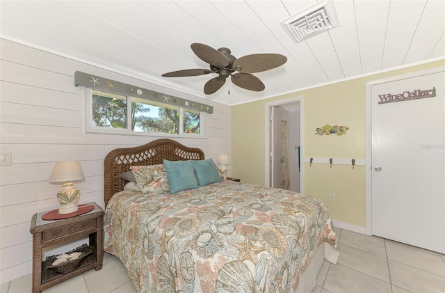 tiled bedroom with crown molding, ceiling fan, and wooden walls