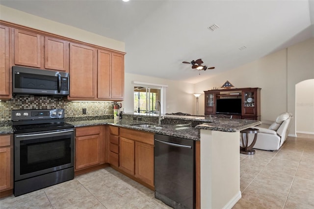 kitchen featuring stainless steel electric stove, black dishwasher, dark stone countertops, sink, and kitchen peninsula