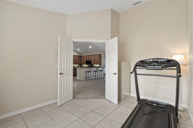 exercise room featuring light tile patterned floors