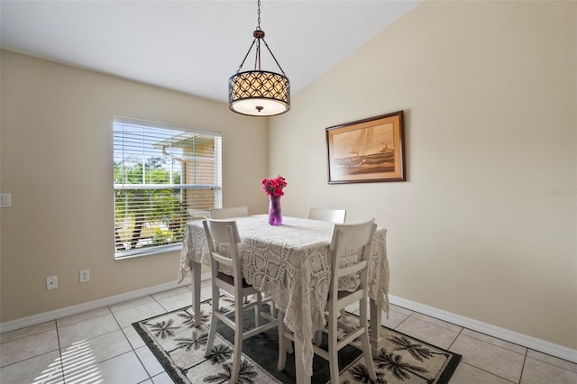 dining space featuring vaulted ceiling and light tile patterned flooring