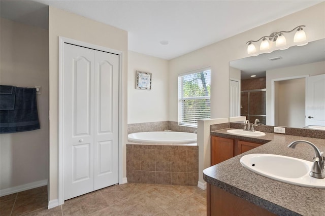 bathroom with tile patterned floors, vanity, and independent shower and bath