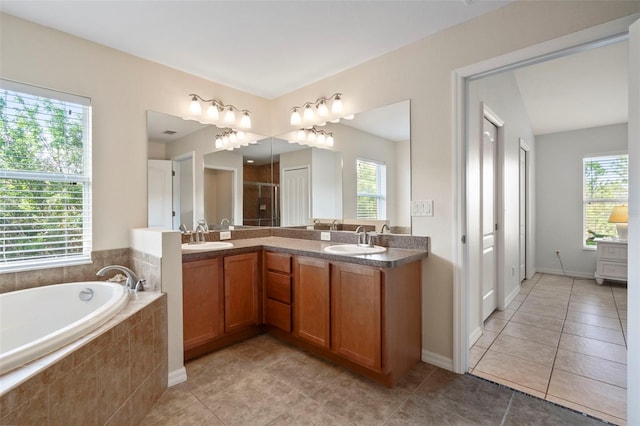 bathroom with vanity, a healthy amount of sunlight, and separate shower and tub