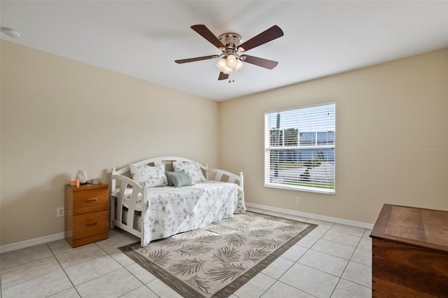 tiled bedroom featuring ceiling fan