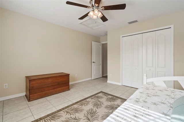 tiled bedroom featuring a closet and ceiling fan