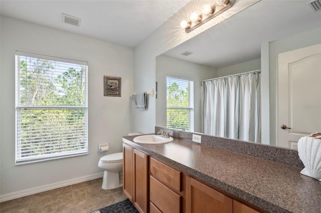 bathroom with vanity, toilet, and tile patterned floors