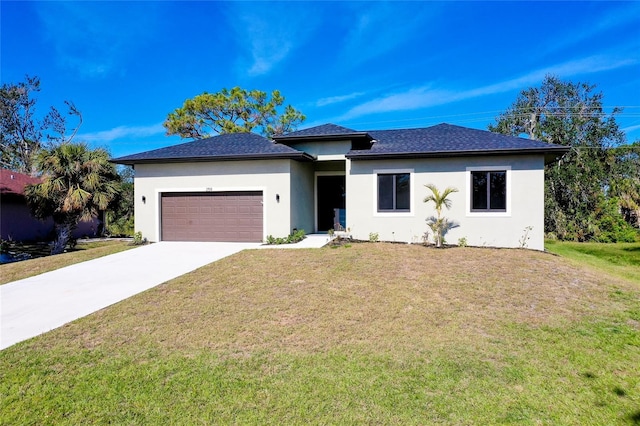 view of front of house featuring a front yard and a garage