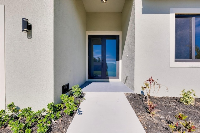 view of exterior entry featuring french doors