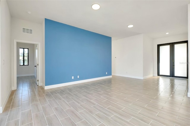 unfurnished room featuring french doors