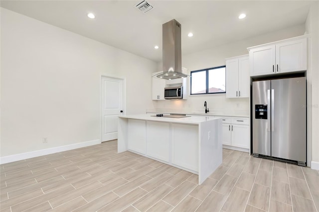 kitchen featuring white cabinetry, sink, island range hood, a kitchen island, and appliances with stainless steel finishes