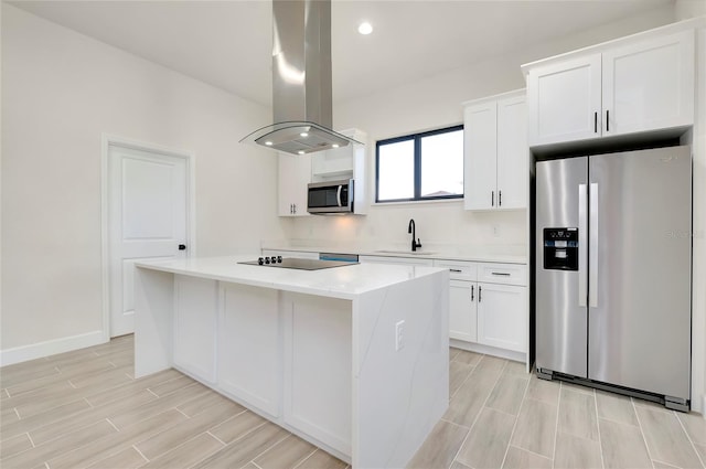 kitchen featuring island exhaust hood, white cabinets, stainless steel appliances, and a kitchen island