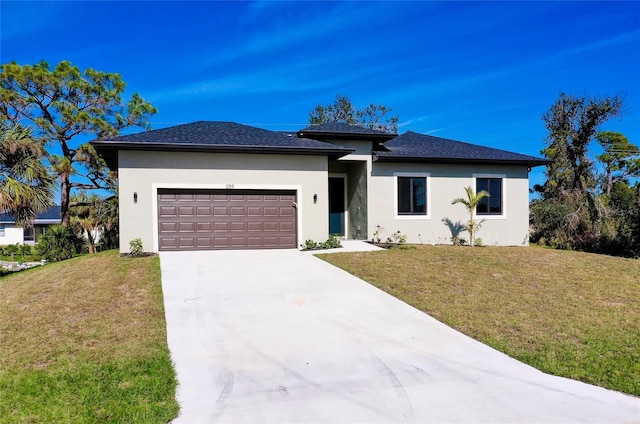 view of front of home with a front yard and a garage