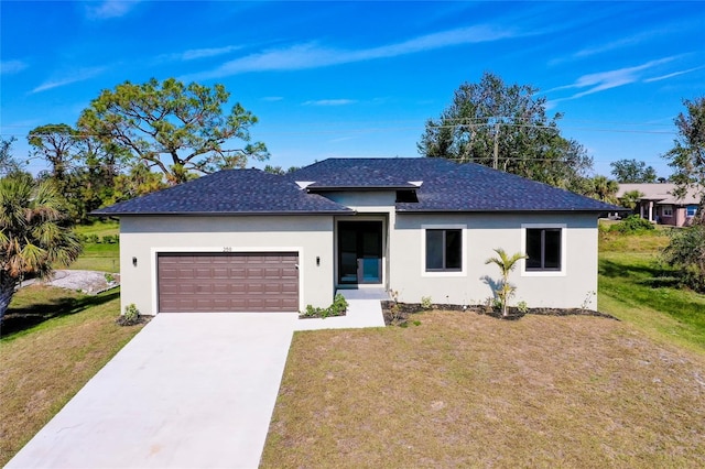 view of front of home featuring a front yard and a garage