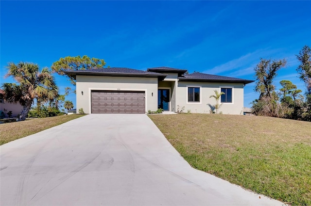 view of front of house featuring a garage and a front lawn