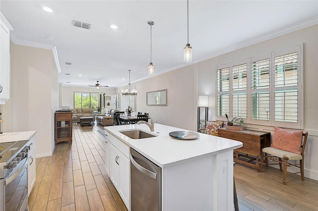 kitchen with appliances with stainless steel finishes, white cabinetry, sink, a kitchen island with sink, and ceiling fan