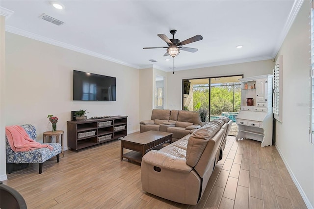 living room with ceiling fan and ornamental molding