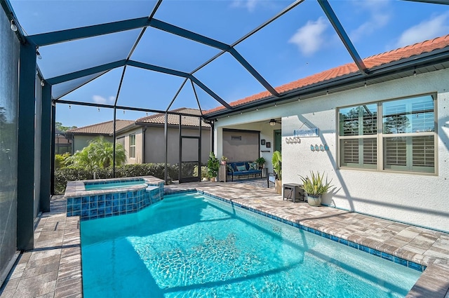 view of swimming pool featuring an in ground hot tub, a lanai, ceiling fan, and a patio