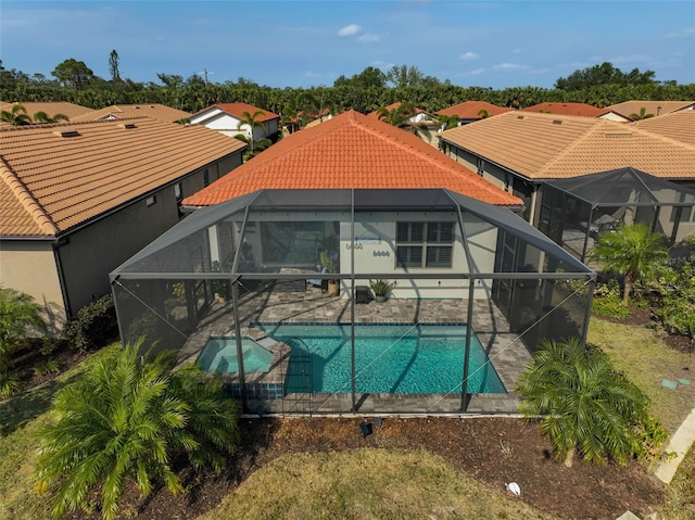 view of swimming pool featuring a patio and glass enclosure