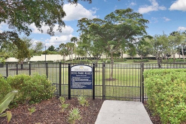 view of gate with a lawn