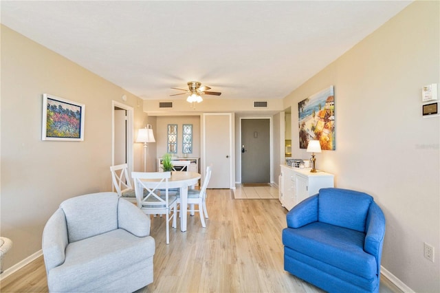 living room with ceiling fan and light hardwood / wood-style floors