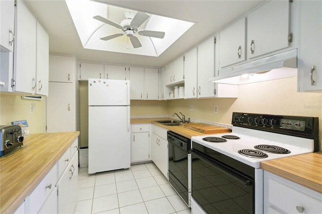 kitchen with a skylight, sink, white cabinets, and white appliances