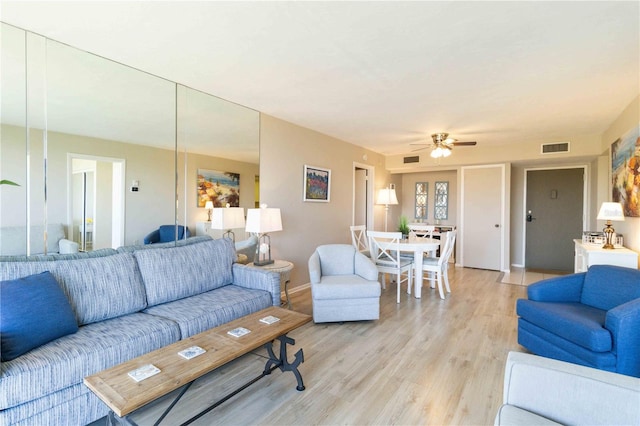 living room with ceiling fan and light hardwood / wood-style floors