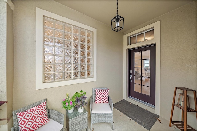 entrance to property with stucco siding