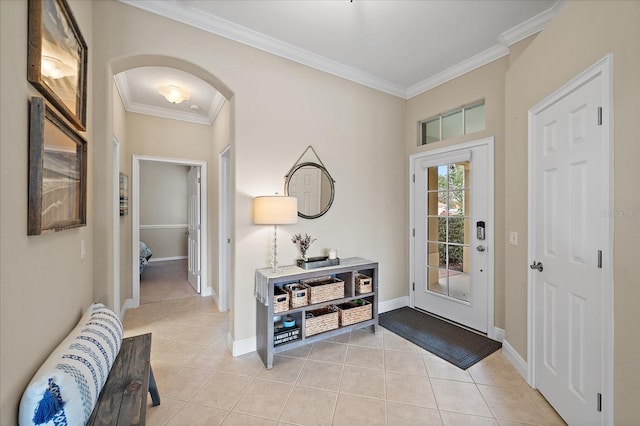 foyer with light tile patterned floors and crown molding