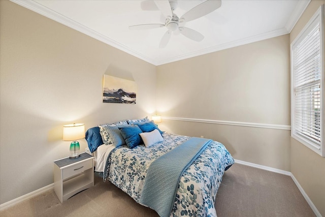 carpeted bedroom with baseboards, ceiling fan, and crown molding